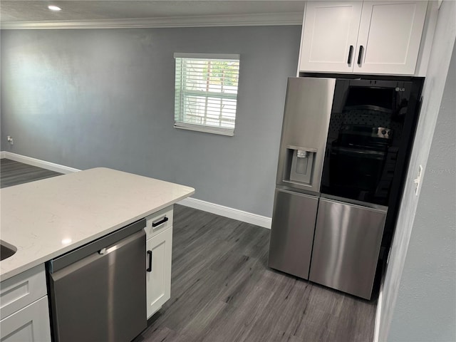 kitchen featuring crown molding, appliances with stainless steel finishes, baseboards, and dark wood-style floors