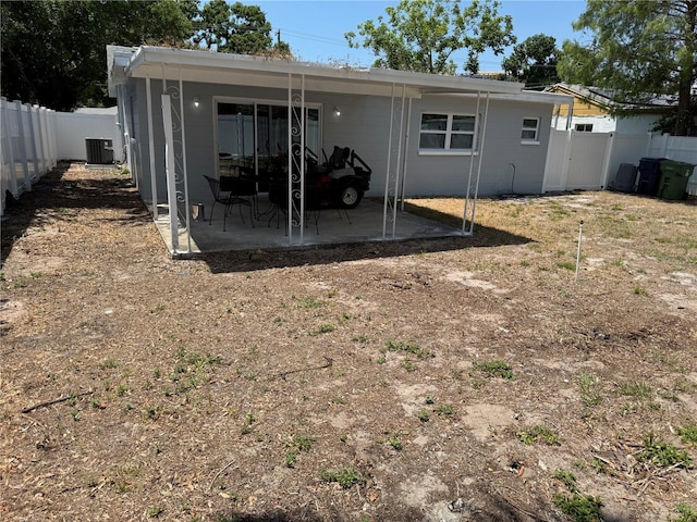 back of property featuring central air condition unit, a patio, and a fenced backyard