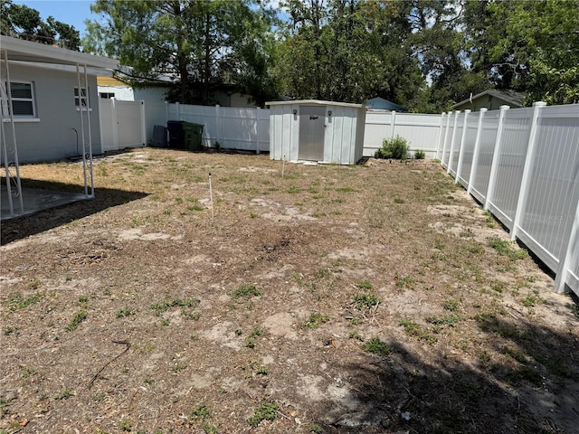 view of yard featuring an outbuilding, a shed, and a fenced backyard