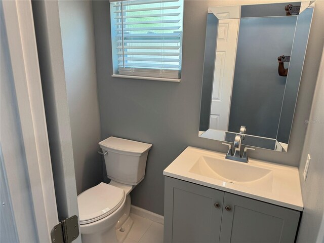 2205 N Grady Ave, Tampa, FL 33607 - bathroom featuring toilet, baseboards, tile patterned flooring, and vanity