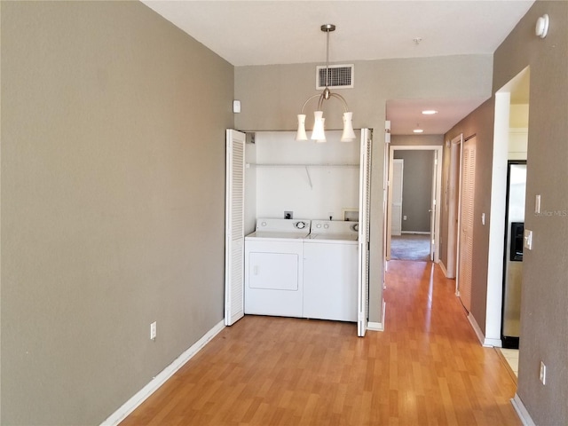 washroom featuring visible vents, baseboards, laundry area, and light wood-style floors