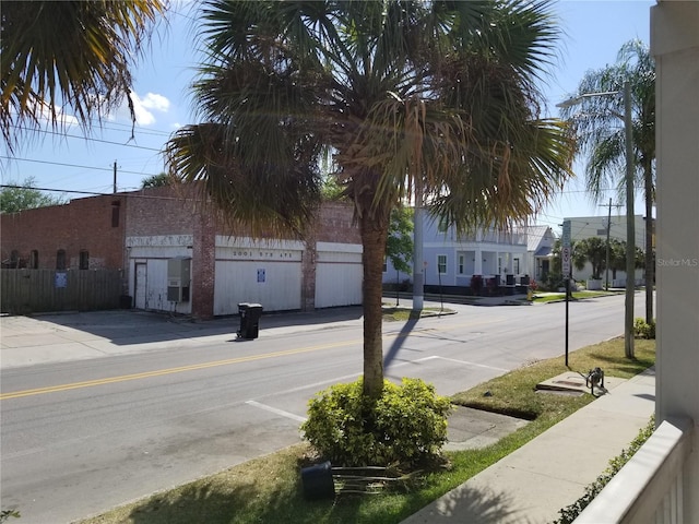 view of road with sidewalks and curbs