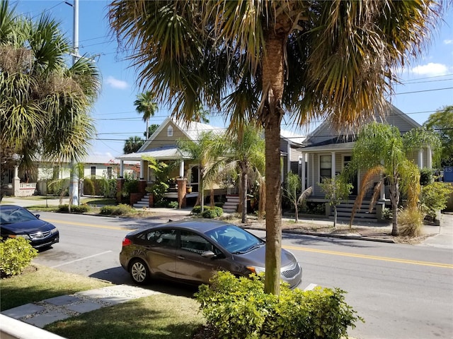 view of street featuring curbs, sidewalks, and stairway