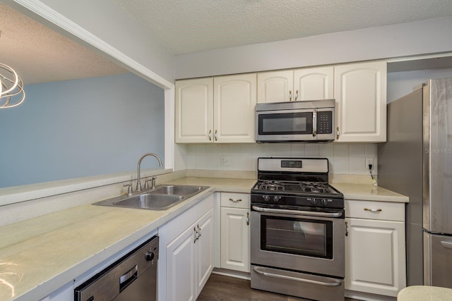 kitchen featuring a sink, white cabinets, stainless steel appliances, and light countertops