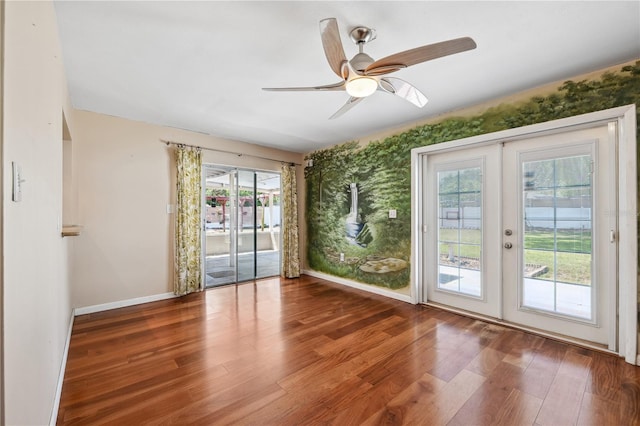 interior space with a ceiling fan, baseboards, french doors, and wood finished floors