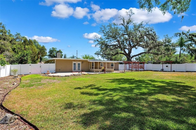 back of house with a fenced backyard, a gate, a patio area, french doors, and a yard