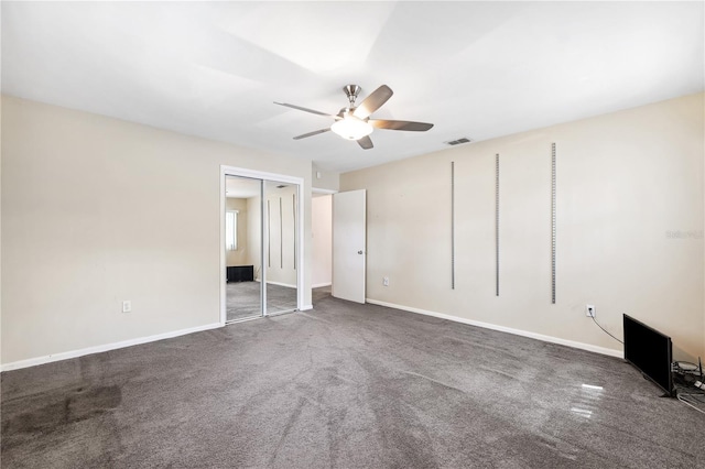 unfurnished bedroom with a ceiling fan, baseboards, visible vents, and carpet