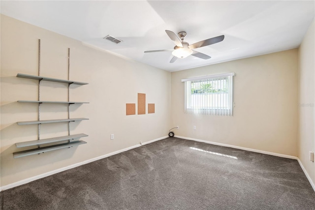 carpeted empty room with ceiling fan, visible vents, and baseboards