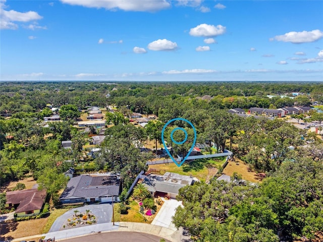 birds eye view of property with a wooded view