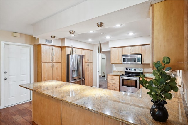kitchen featuring visible vents, a peninsula, light brown cabinetry, light stone countertops, and stainless steel appliances