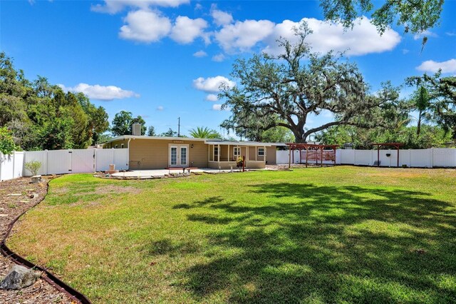 505 S Larry Cir, Brandon, FL 33511 - rear view of property with french doors, a patio area, and a gate