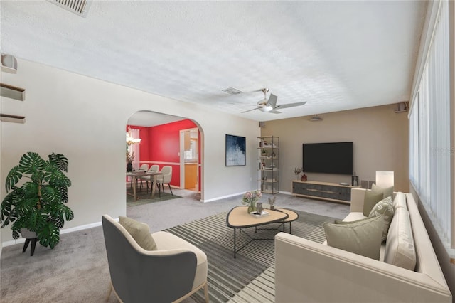 505 S Larry Cir, Brandon, FL 33511 - living room featuring arched walkways, carpet, a ceiling fan, and a textured ceiling