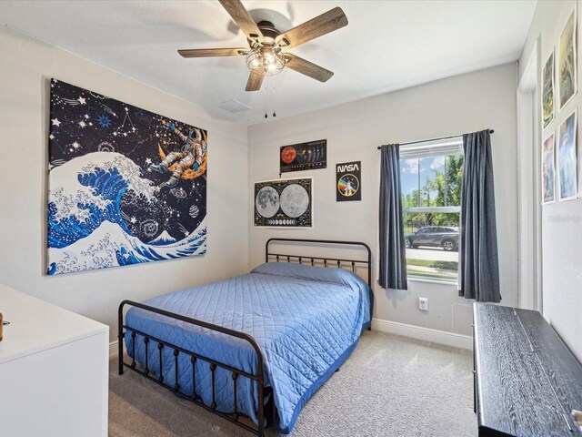 bedroom with carpet floors, baseboards, a ceiling fan, and visible vents