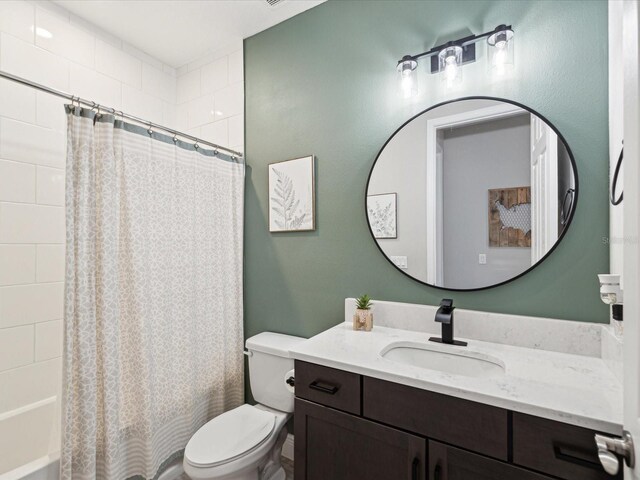 bathroom with vanity, toilet, and shower / tub combo
