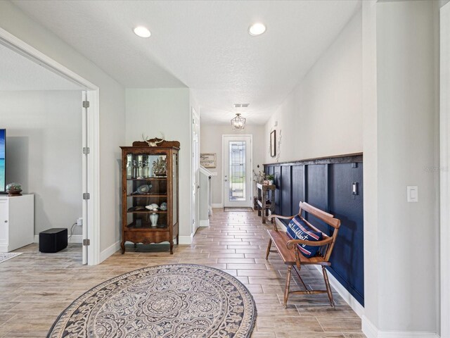foyer with recessed lighting, wood finish floors, visible vents, and baseboards