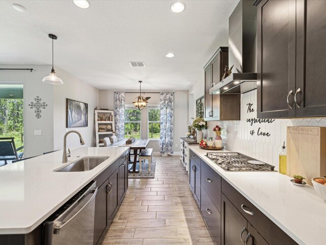 kitchen with light countertops, appliances with stainless steel finishes, and a sink
