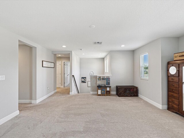 interior space with recessed lighting, baseboards, visible vents, and light carpet
