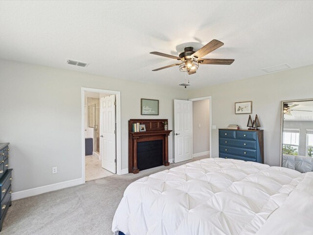 bedroom with baseboards, ceiling fan, light carpet, and visible vents