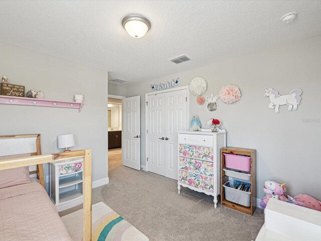 bedroom featuring baseboards, visible vents, carpet, and a closet