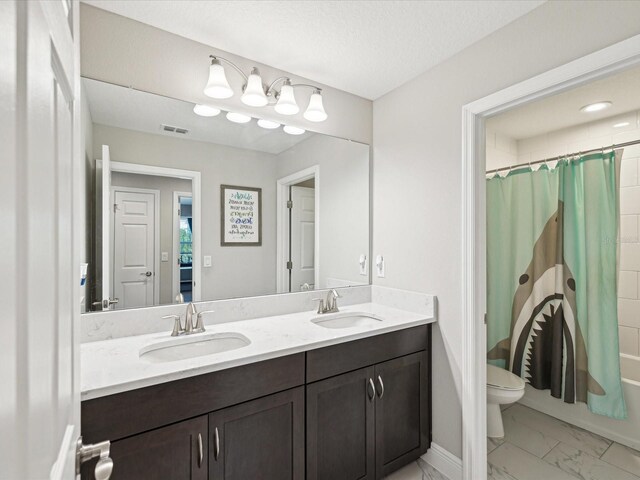 full bath with double vanity, toilet, visible vents, and a sink