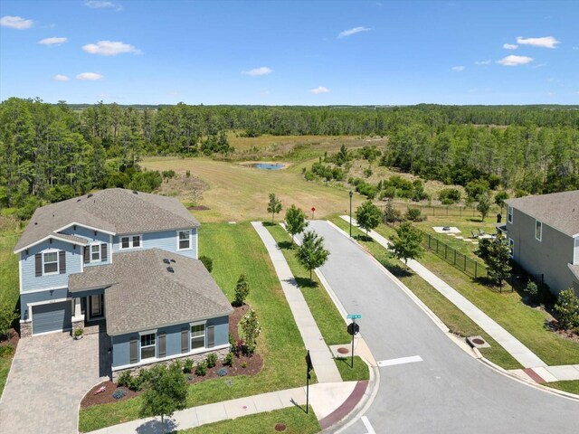 drone / aerial view featuring a water view and a view of trees