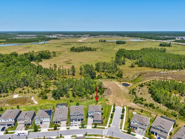 birds eye view of property featuring a water view and a residential view
