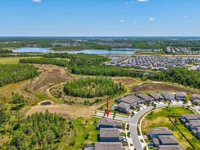 birds eye view of property featuring a water view and a residential view