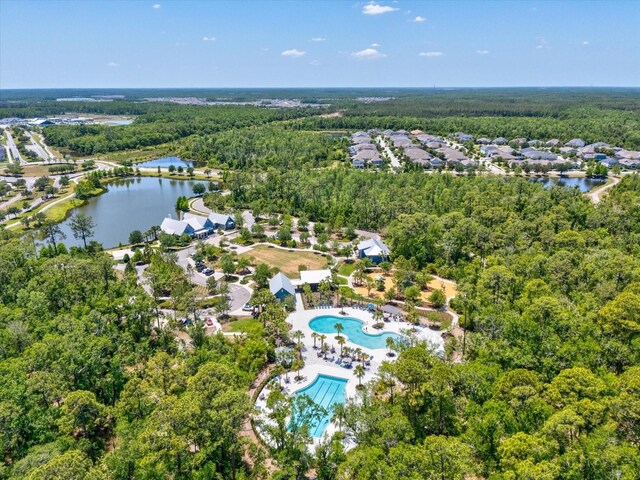 drone / aerial view with a view of trees and a water view