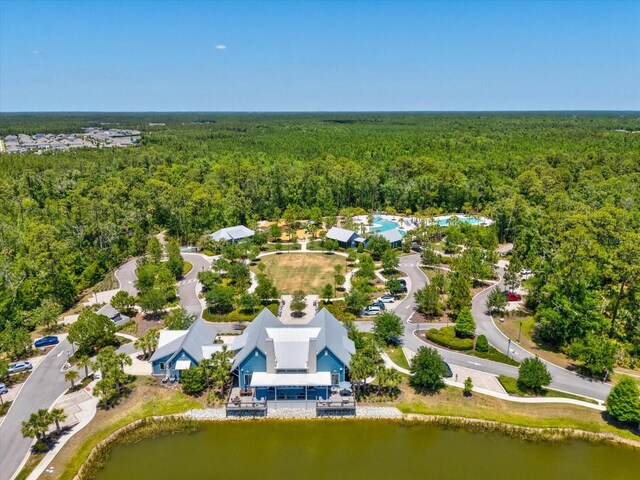 bird's eye view with a water view and a view of trees