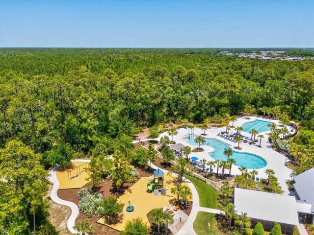 aerial view featuring a wooded view