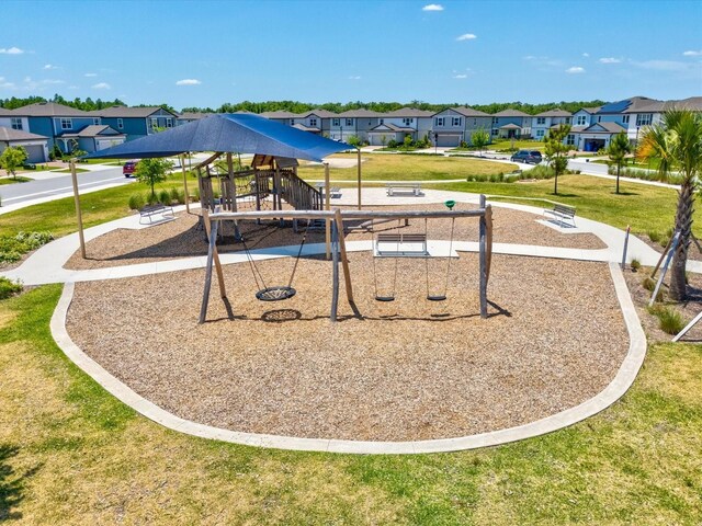 community jungle gym with a residential view and a lawn