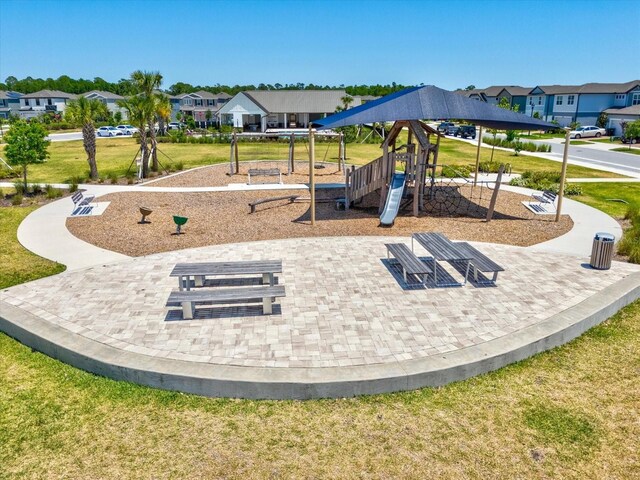 community playground featuring a yard and a residential view
