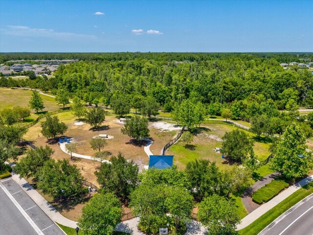 birds eye view of property with a wooded view