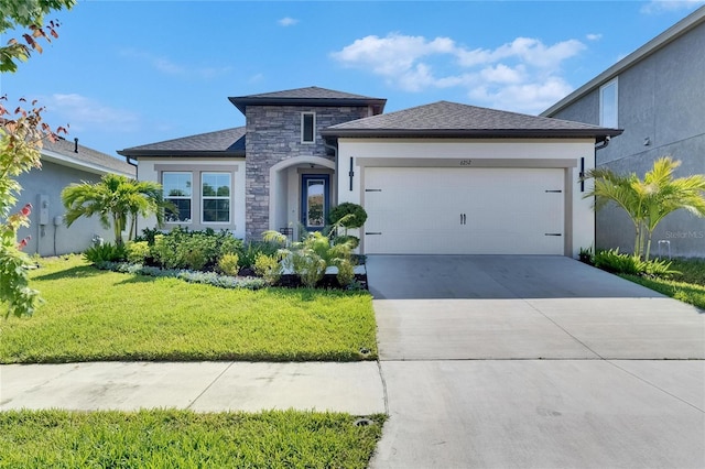 6252 Hidden Branch Dr, Apollo Beach, FL 33572 - view of front of property featuring driveway, a front yard, a garage, stone siding, and stucco siding
