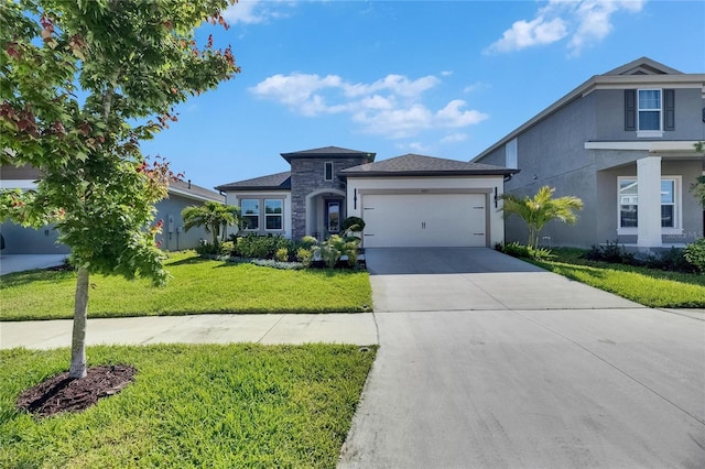 6252 Hidden Branch Dr, Apollo Beach, FL 33572 - view of front of home with a garage, a front lawn, stone siding, stucco siding, and concrete driveway