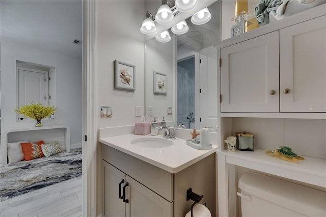 6252 Hidden Branch Dr, Apollo Beach, FL 33572 - bathroom featuring toilet, visible vents, wood finished floors, and vanity