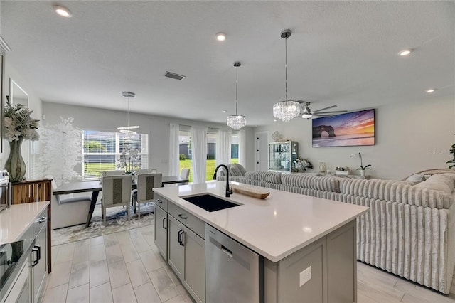 6252 Hidden Branch Dr, Apollo Beach, FL 33572 - kitchen with stainless steel dishwasher, visible vents, open floor plan, a sink, and gray cabinetry