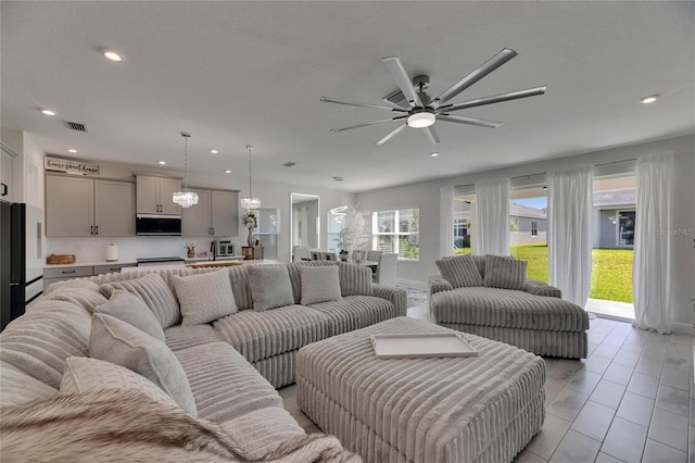 6252 Hidden Branch Dr, Apollo Beach, FL 33572 - living room featuring visible vents, recessed lighting, and ceiling fan with notable chandelier