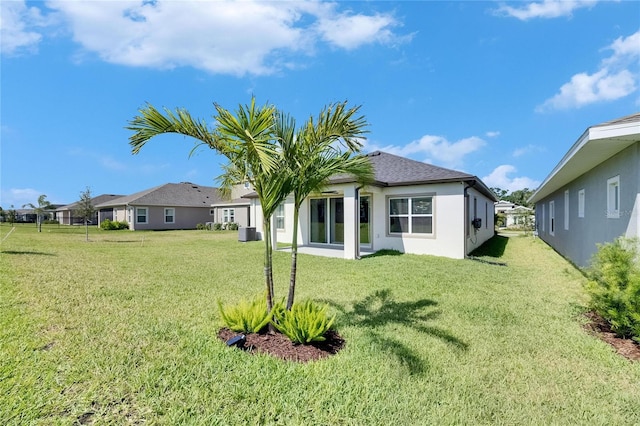 6252 Hidden Branch Dr, Apollo Beach, FL 33572 - back of house with a lawn, central AC unit, stucco siding, and a residential view