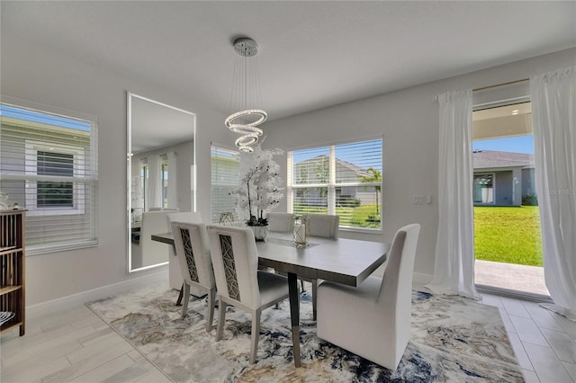 6252 Hidden Branch Dr, Apollo Beach, FL 33572 - dining space featuring an inviting chandelier, baseboards, and a healthy amount of sunlight