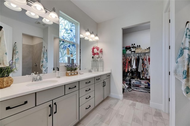 6252 Hidden Branch Dr, Apollo Beach, FL 33572 - full bath featuring a sink, a walk in closet, double vanity, and tiled shower