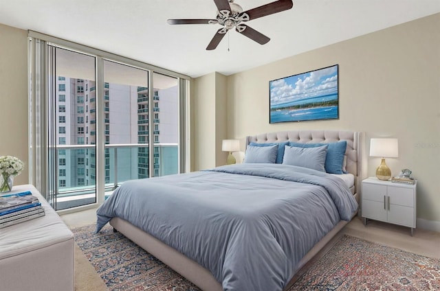 241 Riverside Dr Unit 1107, Daytona Beach, FL 32117 - bedroom with access to exterior, ceiling fan, light carpet, and baseboards
