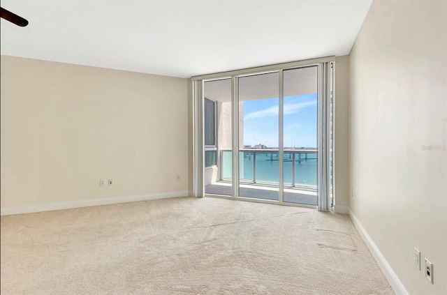 241 Riverside Dr Unit 1107, Daytona Beach, FL 32117 - carpeted spare room featuring expansive windows and baseboards