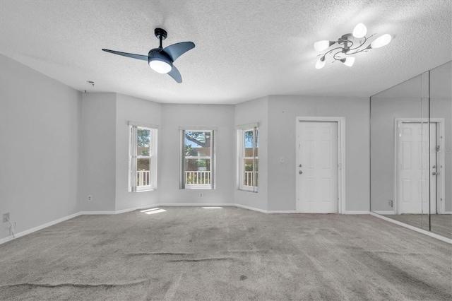 2231 Utopian Dr E Unit 117, Clearwater, FL 33763 - spare room featuring a textured ceiling, carpet flooring, baseboards, and ceiling fan
