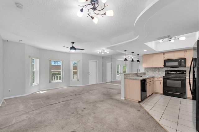 2231 Utopian Dr E Unit 117, Clearwater, FL 33763 - kitchen featuring black appliances, a peninsula, open floor plan, light brown cabinets, and a chandelier