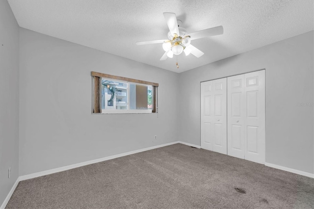 2231 Utopian Dr E Unit 117, Clearwater, FL 33763 - unfurnished bedroom with a textured ceiling, carpet, a closet, and baseboards