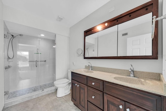 2231 Utopian Dr E Unit 117, Clearwater, FL 33763 - bathroom featuring double vanity, a stall shower, toilet, and tile patterned floors