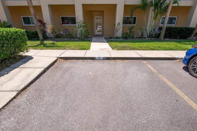 2231 Utopian Dr E Unit 117, Clearwater, FL 33763 - view of front of property featuring a front lawn and uncovered parking