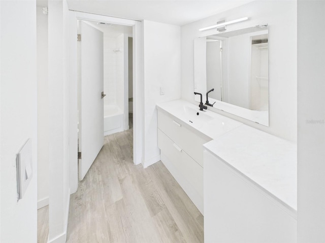 201 W Laurel St Unit 504B, Tampa, FL 33602 - full bath with wood finished floors, vanity, shower / washtub combination, and baseboards
