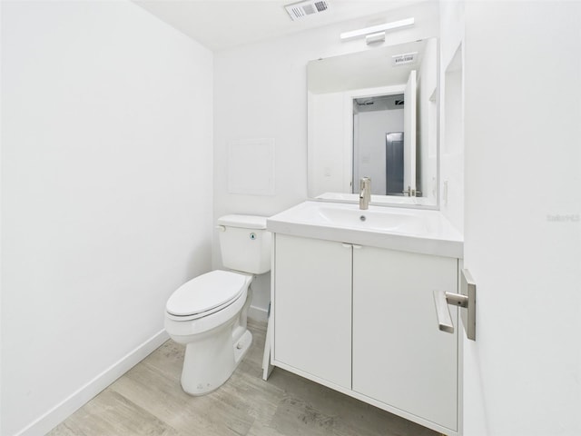 201 W Laurel St Unit 504B, Tampa, FL 33602 - bathroom featuring wood finished floors, vanity, toilet, and baseboards